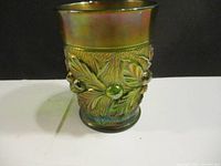 Side view of Northwood carnival glass vase showing detailed acorn burr raised pattern with iridescent amethyst finish.