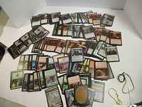 Wide view of many Magic: The Gathering cards spread out face-up showing various colors and card types.