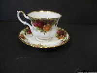 Cup and saucer set showing side profile with floral pattern and gold trim