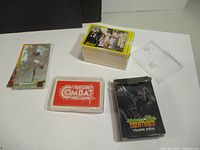 Combat cards laid out with box, Bingo the Movie cards stacked, and Selecta Creature card box visible.