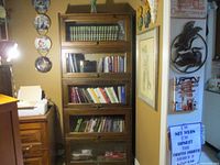Front view of pine bookcase with five glass-front shelves