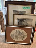 Three framed pieces of black and white artwork stacked, showing different frame styles and sizes