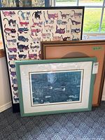 Three framed artworks grouped together including the ranked print and cat-themed print