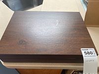 Closed wooden chest containing cutlery set