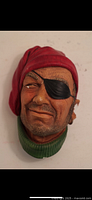Front view of Bosson Head Pirate figurine showing facial details, red bandana, black eye patch, and green collar.