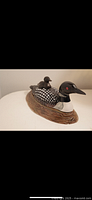 Front view of the loon trinket box showing the larger loon with smaller loon on the lid and detailed base