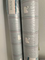 Close-up showing details of the wallpaper roll patterns and labels