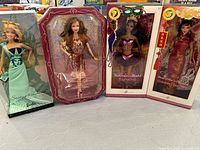 Front view photo of the four Barbie dolls in original unopened boxes showing all dolls and their accessories.