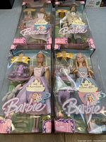 Overhead shot of all four boxed dolls: Rapunzel, Nutcracker, Tea Party, Swan Lake