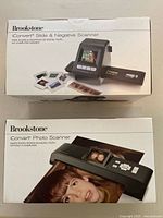 Front and top of boxed Brookstone iConvert Slide & Negative Scanner and Photo Scanner showing product images and usage.
