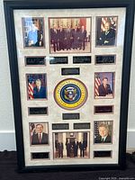 Frontal photo of the entire collectible showing the nine presidential photographs, their signatures, and the printed presidential seal with descriptive plaques, framed in black with beige matting.