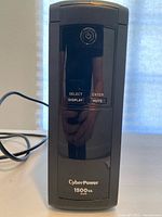 Full front view of CyberPower UPS unit showing power button and control buttons.