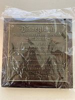 Front of plaque with embossed Disneyland welcome dedication text.