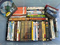 Photo showing a large collection of DVDs and a few VHS tapes, including E.T., Lord of the Rings, Wizard of Oz, Simpsons The Movie, Shrek trilogy, Sideways, Ratatouille, and more.