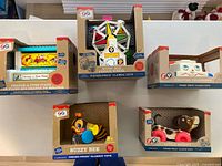 All five Fisher Price Classic Toys displayed unopened in their original boxes, arranged on a table.