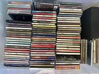 Overview of stacked music CDs with titles visible including Bing Crosby Christmas, Barbra Streisand, Jethro Tull, and more.