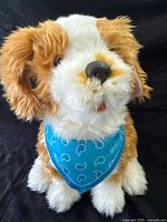 Front view of the robotic plush dog with blue paisley bandana showing head and facial features.