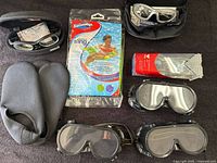 Top down view of all items including booties, goggles and inflatable sling packaging