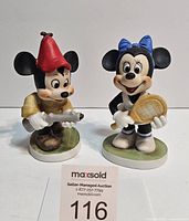 Front view of Mickey Mouse and Minnie Mouse ceramic statues side by side