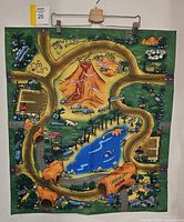 Full view of the child’s dinosaur themed floor play mat showing the entire colorful scene, including volcano, river, and paths.