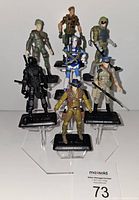 Seven GI Joe action figures arranged on stands, showing various characters and accessories from the 2007 series
