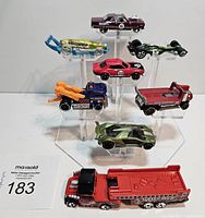 Front and angled view of the 8 Hot Wheels cars arranged on clear display stands, showing the variety of colors and styles.