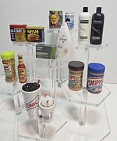 Photo showing all miniature collectible items arranged on acrylic stands.