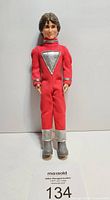 Front view of Mork from Ork doll wearing red jumpsuit with silver details, standing upright against a neutral background with auction lot number.