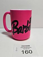 Front view showing 'Barbie' logo in black on pink ceramic mug.