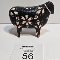 Front side view of the black hand-painted Soldtacka Dala ewe sheep with floral designs