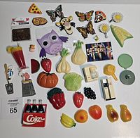 Top-down view of all magnets including food themes, animals, and kitchen item magnets.