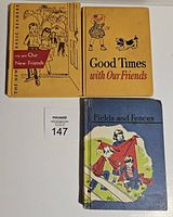 Three vintage children's readers with illustrated covers showing children and animals. Yellow and blue covers visible.