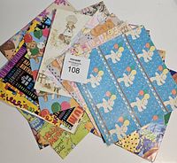 Assortment of vintage children's themed wrapping paper sheets showing bunnies holding balloons, bright colored birthday text prints, and some cartoon characters.