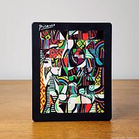 Front view of sliding puzzle showing complete Picasso image in frame
