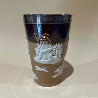 Front profile showing seated boy motif and silver rim