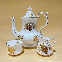 Coffee pot with lid, creamer, sugar bowl front view