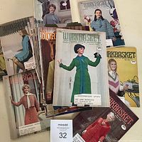 Front view showing several Workbasket magazines with 1970s fashion covers and lot number card