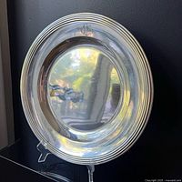 Full view of platter on stand showing rim and reflective surface