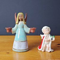 Front view of angel and cherub candleholders