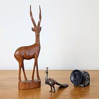 All three figurines grouped for scale comparison