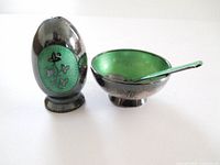 Condiment trio showing pepper shaker, salt bowl, spoon, highlighting green enamel