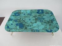 Angled view of tray showing floral top and legs