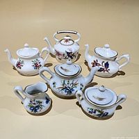 Group shot of all six miniature porcelain pieces