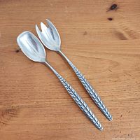 Front view of spoon and fork showing dragon back handles and bowls