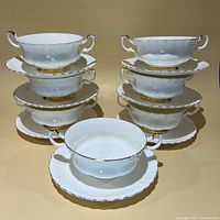 Stacked view of all seven bowl-and-saucer sets