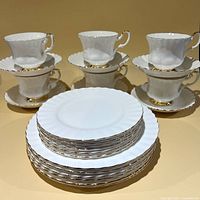 Stacked plates, cups and saucers showing complete set