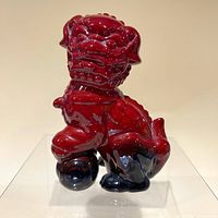 Front view of red flambe glazed Dog of Fo figurine