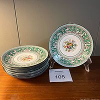 Stack of eight saucers with one displayed on stand