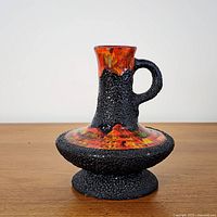 Front view of fat lava ewer highlighting glaze colors and handle
