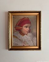 Frontal view of framed oil painting showing young woman in red headscarf